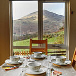 Perthi Holiday Cottages, Beddgelert - dining table and mountain view Perthi Holiday Cottages, Beddgelert - dining table and mountain view